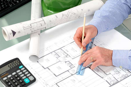 Engineer at work in the office on a residential construction project.の写真素材