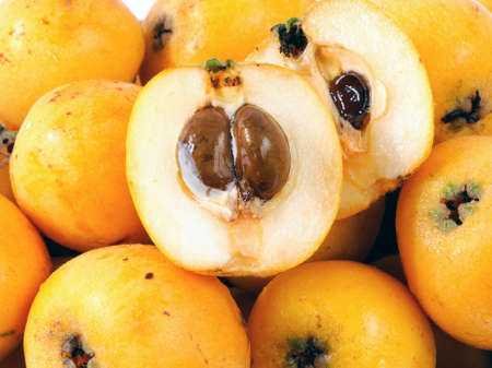 Medlars produced with organic cultivation photograph on a white backgroundの写真素材