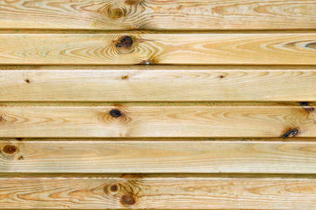 Closeup of a rustic wall built with natural wood planksの写真素材