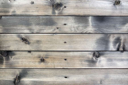 Closeup of a rustic wall built with natural wood planksの写真素材