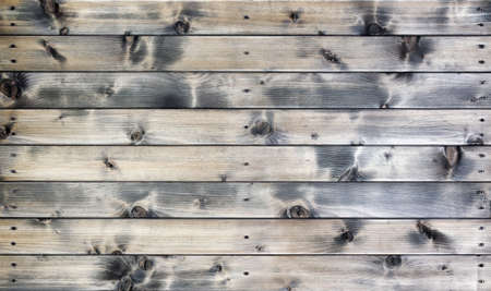 Closeup of a rustic wall built with natural wood planksの写真素材