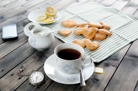 Foods of the Italian breakfast with tea and biscuits on an old wooden tableの写真素材