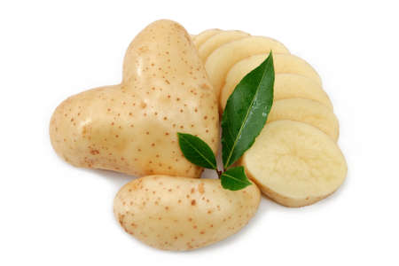 Front view of a potato heart shaped and slices, decorated with bay leavesの写真素材