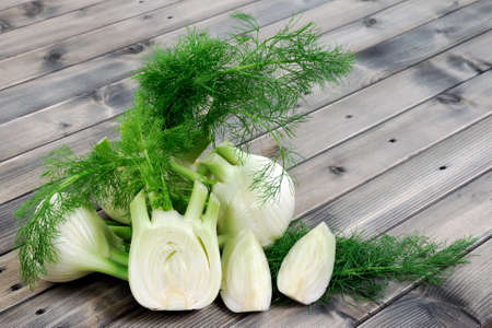 Fresh fennel cut just harvested, photographed on wooden tableの写真素材