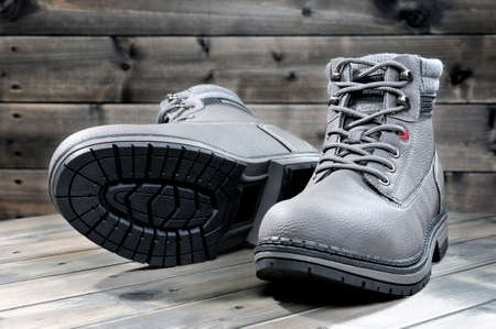 Closeup of winter men's shoes photographed on a background old wood.の写真素材