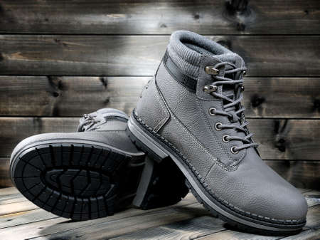 Closeup of winter men's shoes photographed on a background old wood.の写真素材