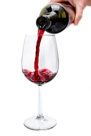 Pour an excellent red vintage wine in an elegant crystal goblet, isolated on white background.の写真素材