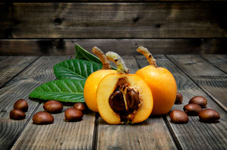 Medlars produced with organic cultivation photographed on antique wood backgroundの写真素材