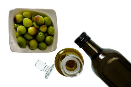 Shot from above of fresh olives freshly harvested and extra virgin olive oil isolated on white backgroundの写真素材