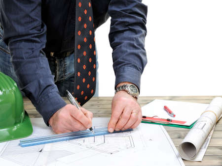 Engineer works on the project on an aged wooden desk, isolated on white background