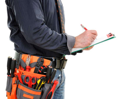 Elegant electrician technician takes notes on notepad, isolated on white.の写真素材