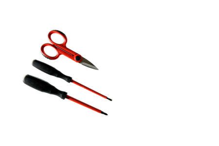 Scissors and screwdrivers for working on a residential electrical installation on a white background