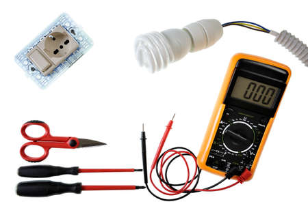 Scissors, screwdrivers, switch, socket, lamp holder, tester, light bulb, electric cable and sheath for a residential electrical installation, photographed on a white backgroundの写真素材