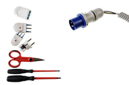 Scissors, screwdrivers, plugs, sockets, electric cable and sheath for a residential electrical installation, photographed on a white backgroundの写真素材