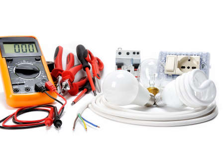 Multimeter, work tools and components for a residential electrical installation, photographed on a white background.の写真素材