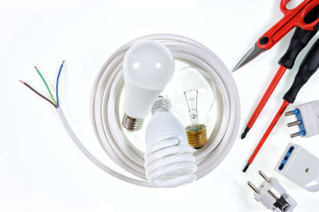 Close-up of work tools and components for a residential electrical installation, photographed on a white background.の写真素材