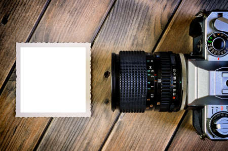 Top view of a 35mm film camera and white space for text on a rustic wooden tableの写真素材