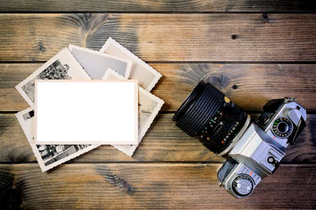 Top view of a 35mm camera, vintage photo and white space for text on a rustic wooden tableの写真素材