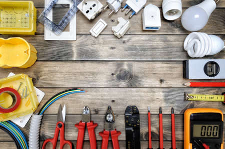 Close-up of work tools and electrical equipment on an antique wooden table with space for text / announcementの写真素材