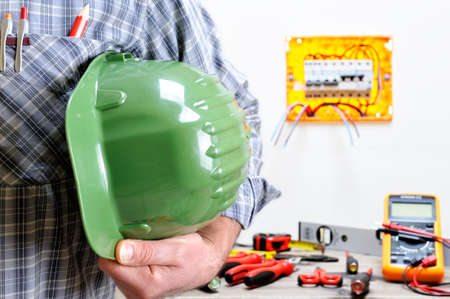 Electrician technician with protection helmet in his handの写真素材