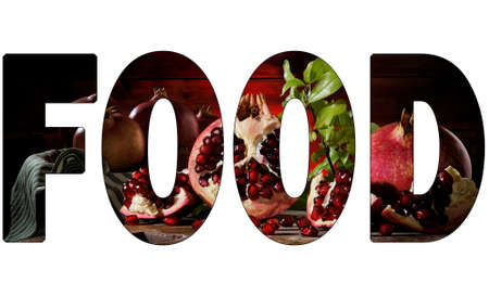 Close up of fresh ripe pomegranates and seeds on an old wood chopping boardの写真素材