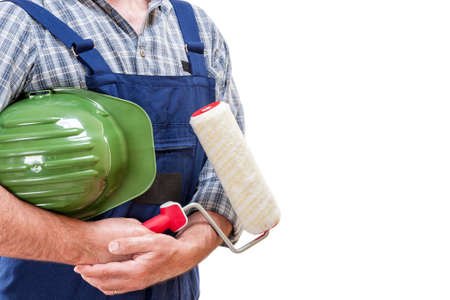 Workman house painter at work with roller and helmet in hand, isolated on white backgroundの写真素材