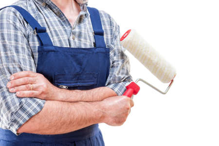 Workman house painter at work with roller in hand, isolated on white backgroundの写真素材
