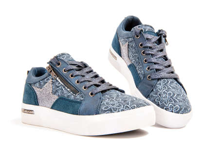 Close-up of girl's shoes for leisure photographed on a white background.の写真素材