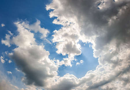 Landscape of a beautiful blue sky covered with cumulonimbus clouds on a warm summer afternoonの写真素材