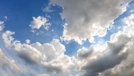 Landscape of a beautiful blue sky covered with cumulonimbus clouds on a warm summer afternoonの写真素材