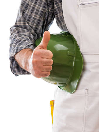 Construction worker in white work overalls with thumb up. Equipped with protective helmet. Isolated on white background. Construction industry.の写真素材