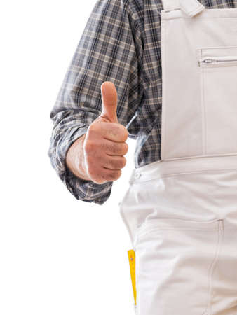 Construction worker in white work overalls with thumb up. Isolated on white background. Construction industry.の写真素材