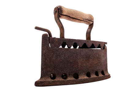 Close up of an antique and rusty iron from coal ironing with wooden handle, isolated on white...