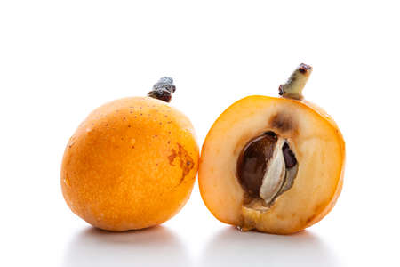 Fresh loquats freshly picked in an organic cultivation, photographed on a white background. Natural...