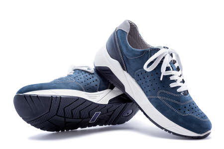 Close up of elegant light blue sports shoes in natural nubuck leather for adult men photographed on a white background. Fashion accessories.の写真素材