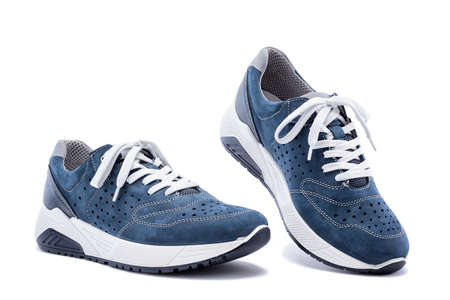 Close up of elegant light blue sports shoes in natural nubuck leather for adult men photographed on a white background. Fashion accessories.の写真素材