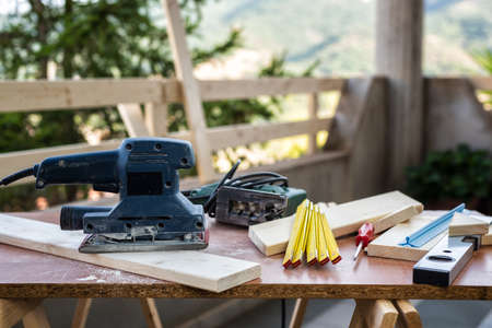 Professional woodworking tools, electric sander to smooth the wood. Housework do it yourself. Stock photography.の写真素材