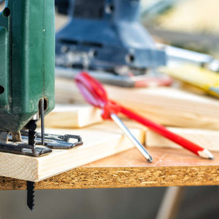 Professional woodworking tools, manual electric saw for cutting wood. Housework do it yourself. Stock photography.の写真素材