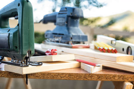 Professional woodworking tools, manual electric saw for cutting wood. Housework do it yourself. Stock photography.の写真素材