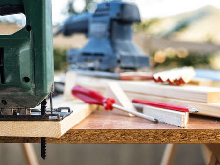 Professional woodworking tools, manual electric saw for cutting wood. Housework do it yourself. Stock photography.の写真素材