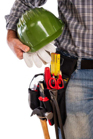Adult craftsman carpenter isolated on white background, he is holding his helmet and leather work gloves. Work tools industry construction, do it yourself housework. Stock photography.の写真素材
