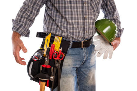 Adult craftsman carpenter isolated on white background, he is holding his helmet and leather work gloves. Work tools industry construction, do it yourself housework. Stock photography.の写真素材