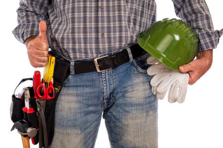 Adult craftsman carpenter isolated on white background making ok sign with thumb up, holding helmet and leather work gloves. Work tools industry construction, do it yourself housework. Stock photography.の写真素材