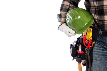 Adult craftsman carpenter isolated on white background, he wears leather work gloves and holds a protective helmet. Work tools industry construction and do it yourself housework. Stock photography.の写真素材