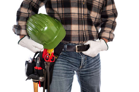 Adult craftsman carpenter isolated on white background, he wears leather work gloves and holds a protective helmet. Work tools industry construction and do it yourself housework. Stock photography.の写真素材