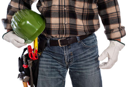 Adult craftsman carpenter isolated on white background, he wears leather work gloves and holds a protective helmet. Work tools industry construction and do it yourself housework. Stock photography.の写真素材