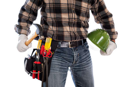 Adult craftsman carpenter isolated on white background, he wears leather work gloves, he is holding a carpenterâs hammer and a protective helmet. Work tools industry construction and do it yourself housework. Stock photography.の写真素材