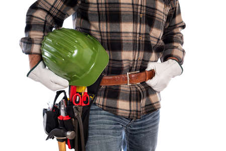 Adult craftsman carpenter isolated on white background, he wears leather work gloves and holds a protective helmet. Work tools industry construction and do it yourself housework. Stock photography.の写真素材