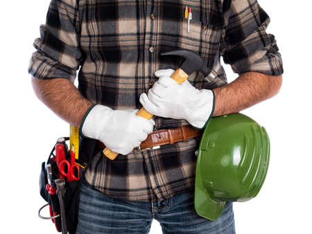 Adult craftsman carpenter isolated on white background, he wears leather work gloves, he is holding a carpenterâs hammer. Work tools industry construction and do it yourself housework. Stock photography.の写真素材