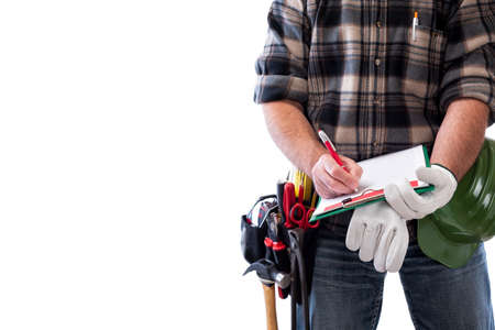 Carpenter isolated on white background writes work notes on a notebook. Work tools industry construction and do it yourself housework. Stock photography.の写真素材